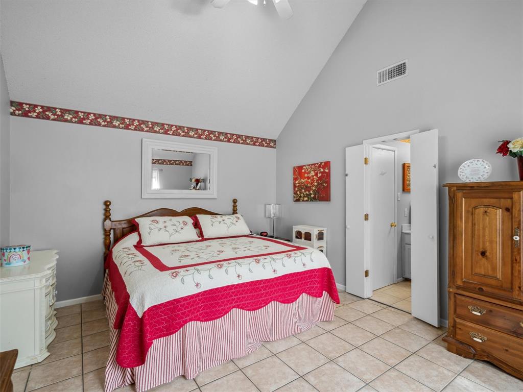 299 Lamplight Path Holly Lake Ranch, TX 75765 - Photo 20 of 40 a bedroom with a bed and a refrigerator