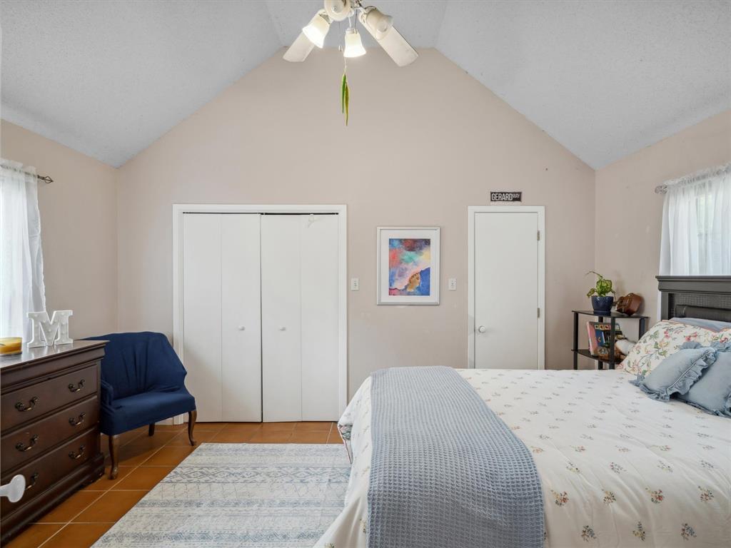 299 Lamplight Path Holly Lake Ranch, TX 75765 - Photo 22 of 40 a bedroom with a bed and a chandelier