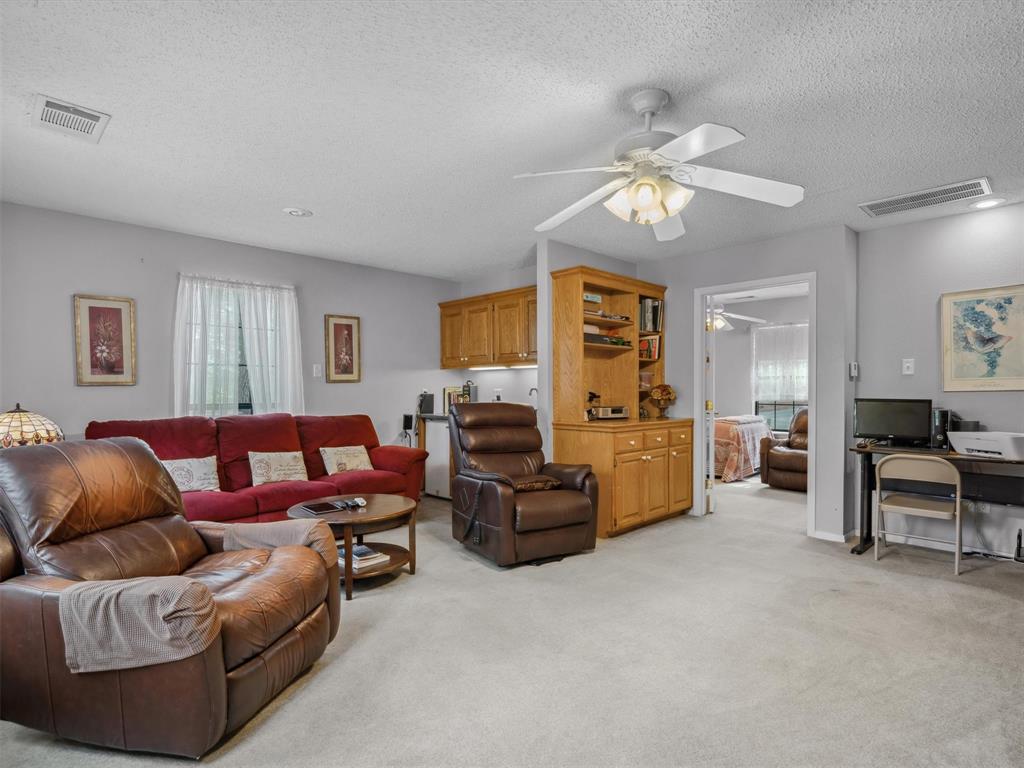 299 Lamplight Path Holly Lake Ranch, TX 75765 - Photo 25 of 40 a living room with furniture ceiling fan and a window