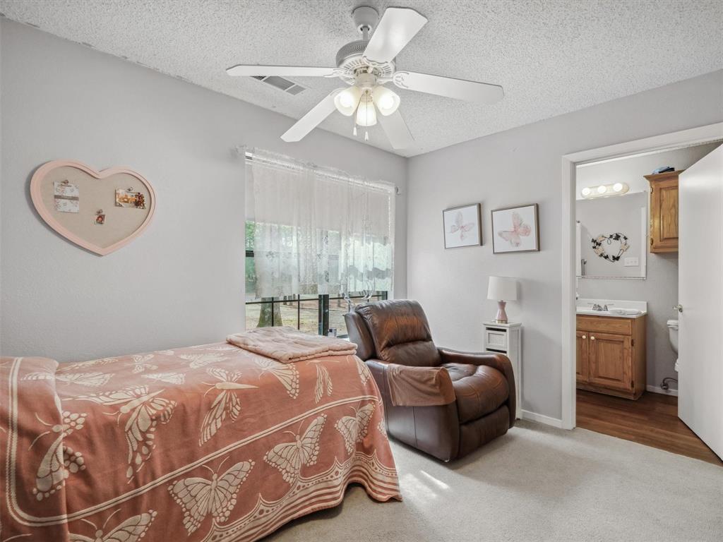 299 Lamplight Path Holly Lake Ranch, TX 75765 - Photo 28 of 40 a bedroom with a bed and ceiling fan