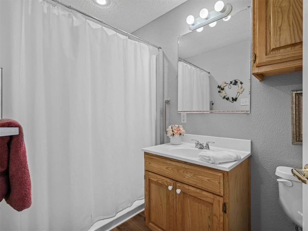 299 Lamplight Path Holly Lake Ranch, TX 75765 - Photo 29 of 40 a bathroom with a sink and a mirror