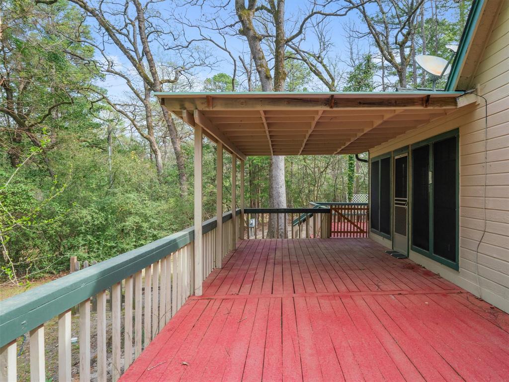 299 Lamplight Path Holly Lake Ranch, TX 75765 - Photo 30 of 40 a view of backyard with a deck and wooden floor