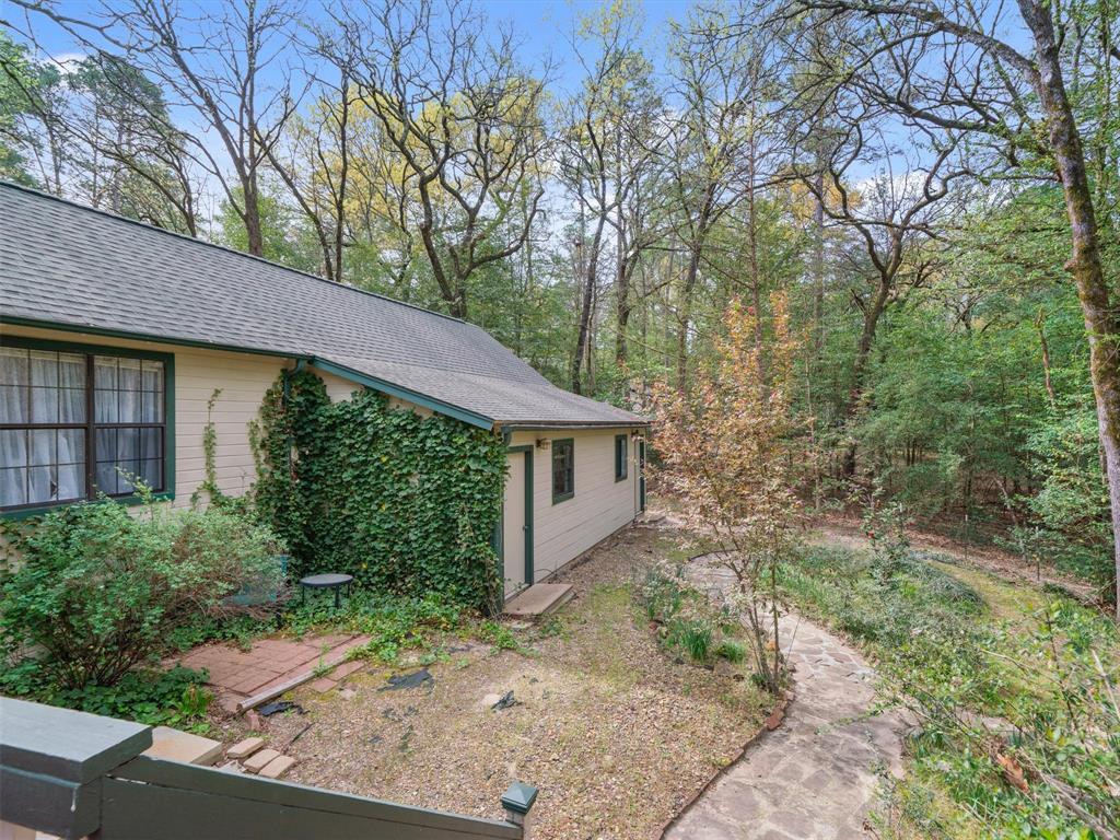 299 Lamplight Path Holly Lake Ranch, TX 75765 - Photo 35 of 40 a backyard of a house with lots of green space