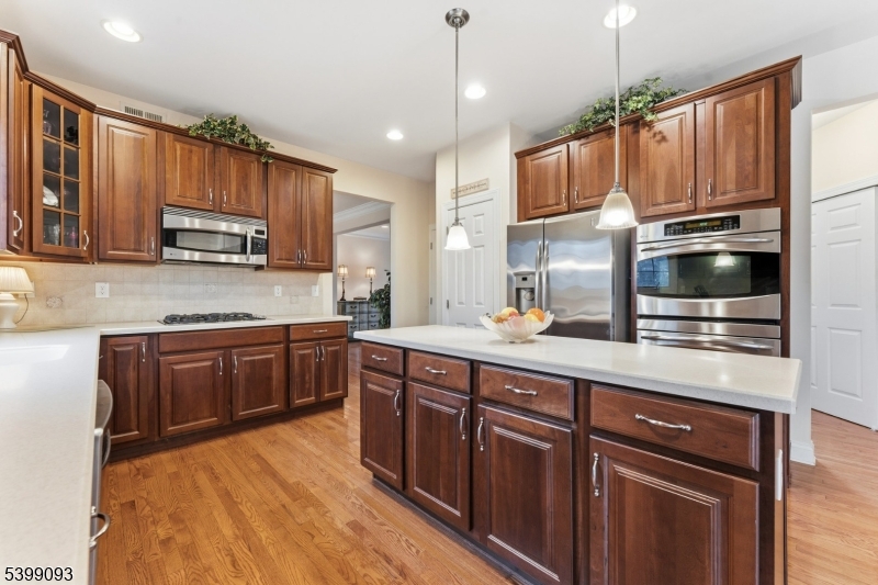 26 Rouser Way Hillsborough, NJ 08844 - Photo 12 of 50 a kitchen with stainless steel appliances granite countertop wooden cabinets a stove top oven a sink and dishwasher
