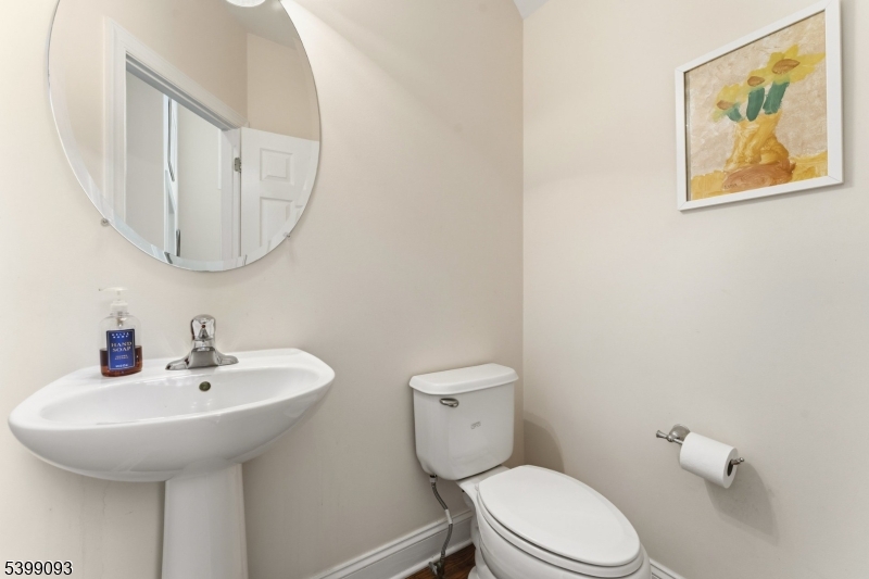 26 Rouser Way Hillsborough, NJ 08844 - Photo 23 of 50 a bathroom with a toilet a sink and mirror