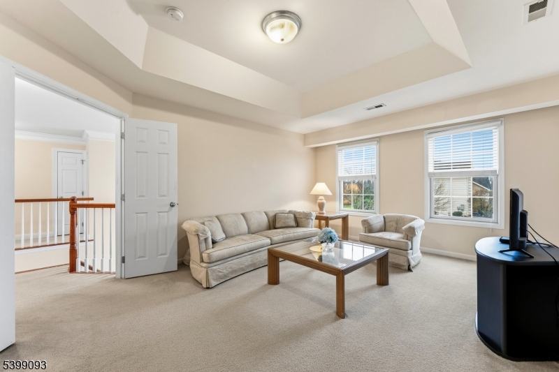 26 Rouser Way Hillsborough, NJ 08844 - Photo 25 of 50 a living room with furniture a flat screen tv and a large window