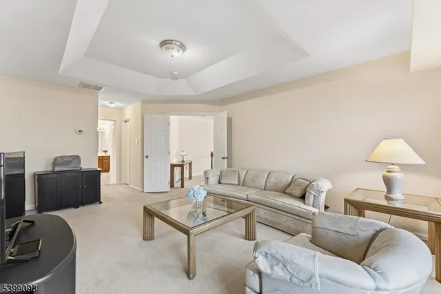 a living room with furniture and a lamp