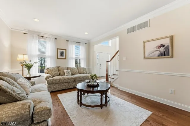 a living room with furniture a rug and a painting
