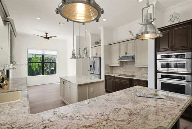 a bathroom with a granite countertop toilet sink and mirror