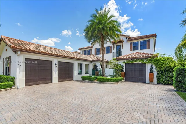 front view of a house with a yard and potted plants