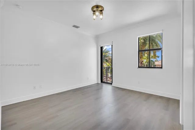 a living room with fireplace furniture and a large window