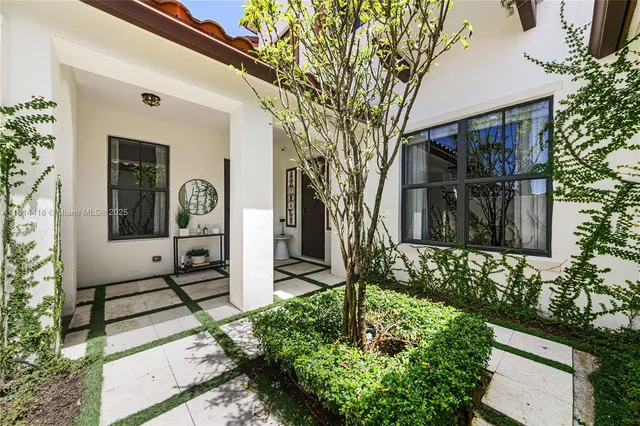 a front view of a house with garden