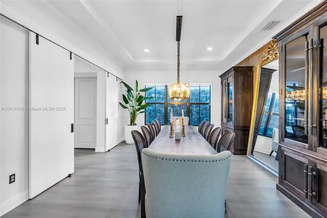 a kitchen with kitchen island granite countertop appliances cabinets and a sink