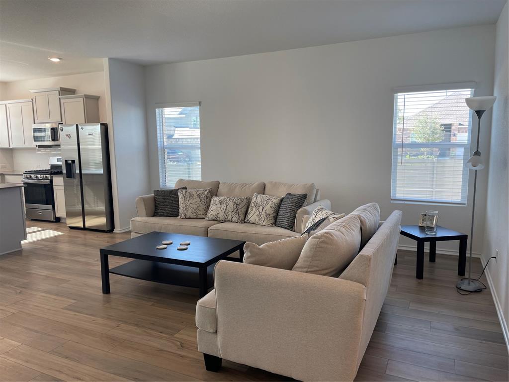 129 Starflower Cove Georgetown, TX 78628 - Photo 5 of 31 Living room featuring dark wood-type flooring, plenty of natural light, and recessed lighting