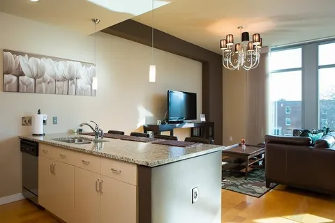 a kitchen with a sink stove and cabinets