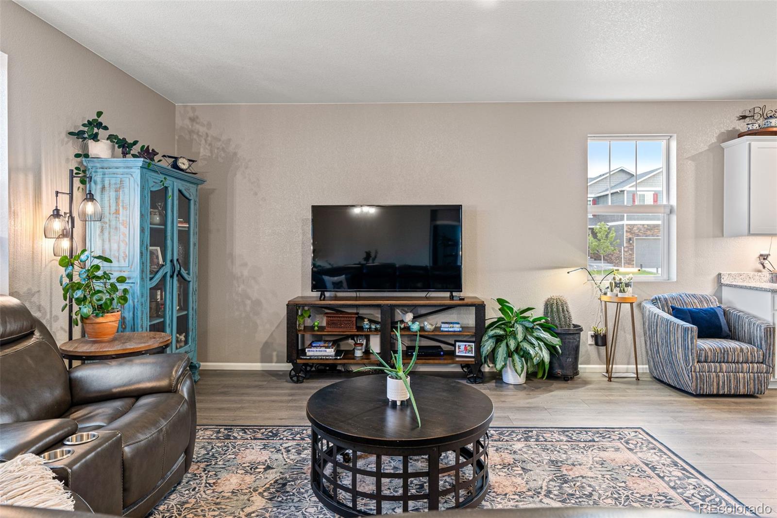 10054 Carefree Street Firestone, CO 80504 - Photo 12 of 50 a living room with furniture and a flat screen tv