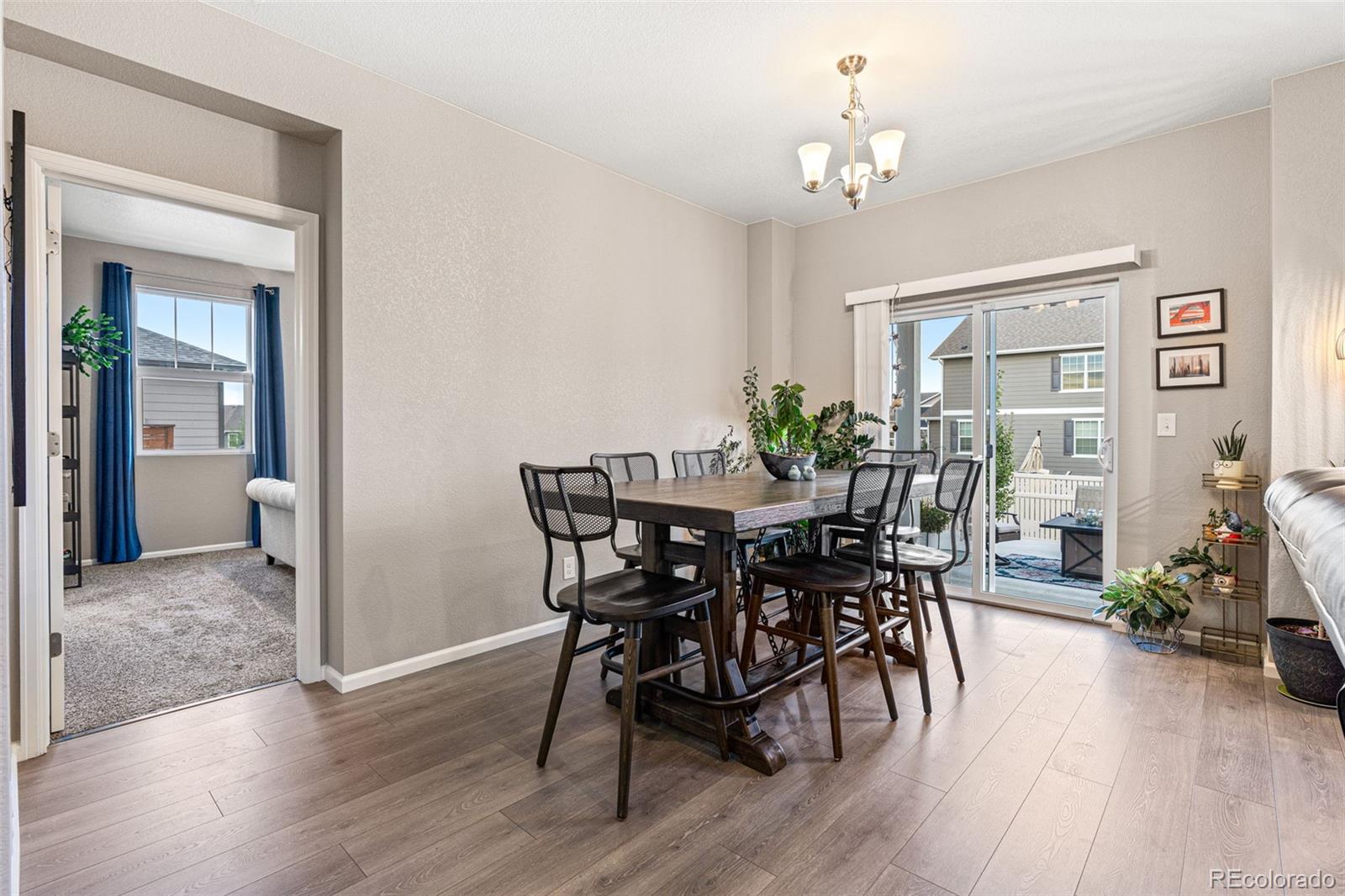 10054 Carefree Street Firestone, CO 80504 - Photo 13 of 50 a view of a dining room with furniture and wooden floor