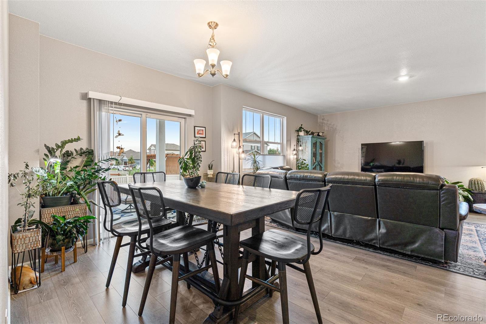 10054 Carefree Street Firestone, CO 80504 - Photo 15 of 50 a view of a dining room with furniture and wooden floor