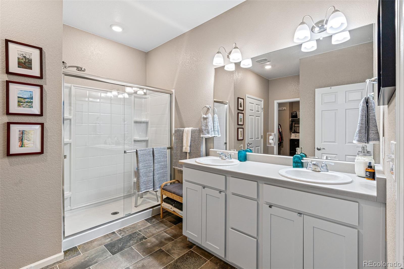 10054 Carefree Street Firestone, CO 80504 - Photo 27 of 50 a spacious bathroom with a shower sink mirror and
