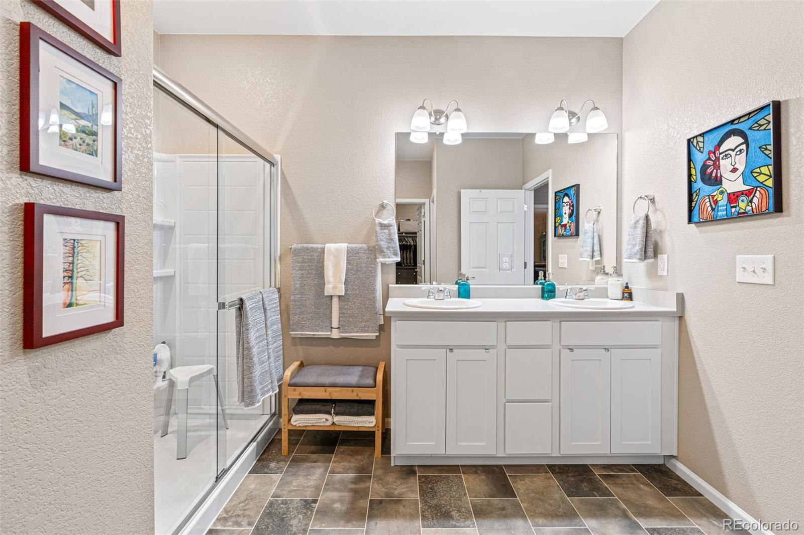 10054 Carefree Street Firestone, CO 80504 - Photo 28 of 50 a bathroom with a sink vanity and a mirror