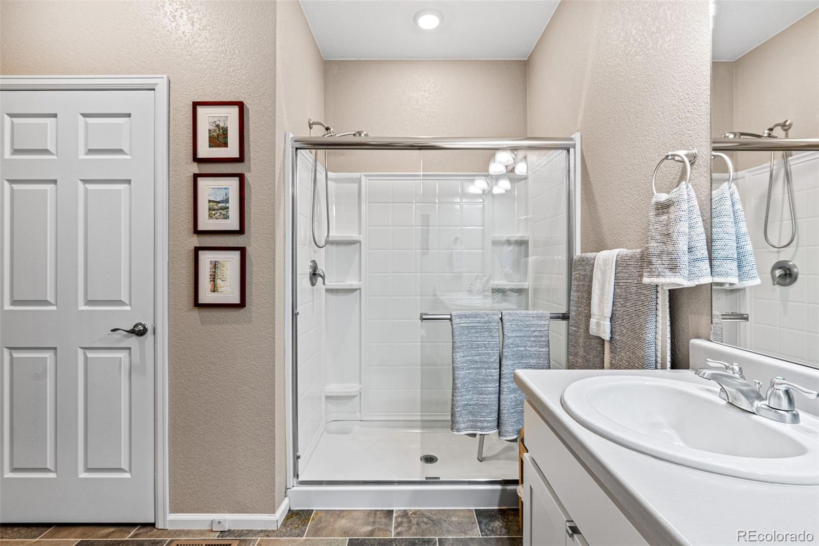 10054 Carefree Street Firestone, CO 80504 - Photo 29 of 50 a bathroom with a shower sink and mirror
