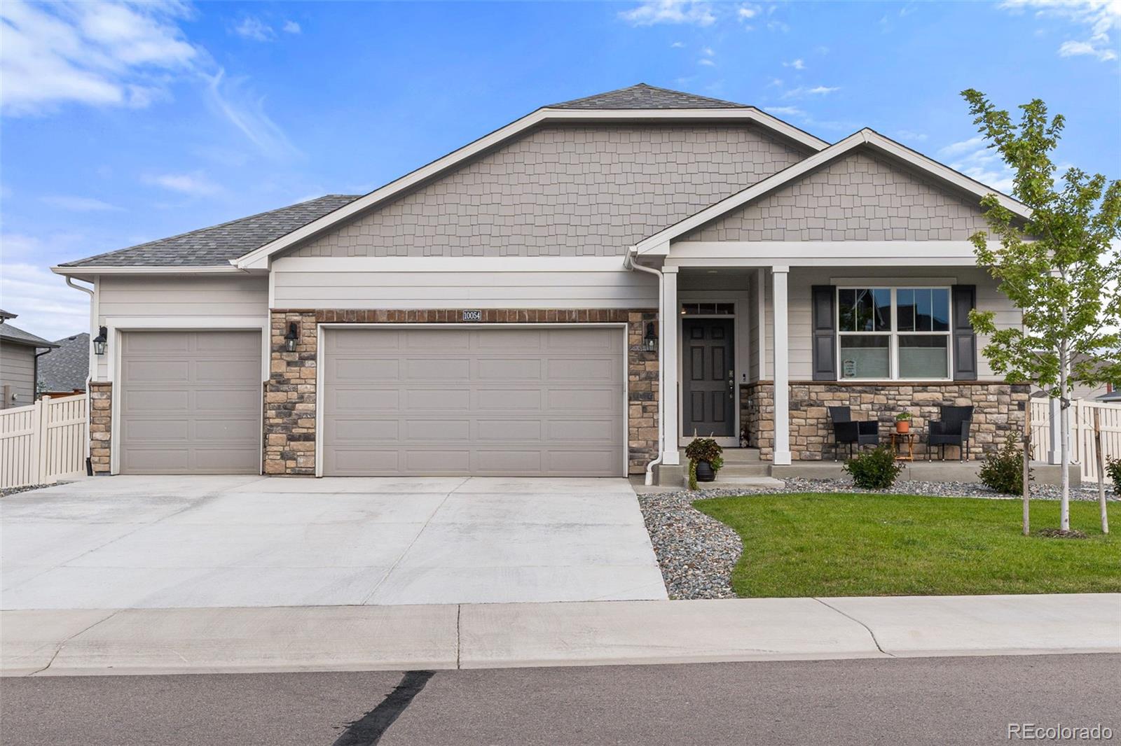 10054 Carefree Street Firestone, CO 80504 - Photo 3 of 50 a front view of a house with a yard and garage