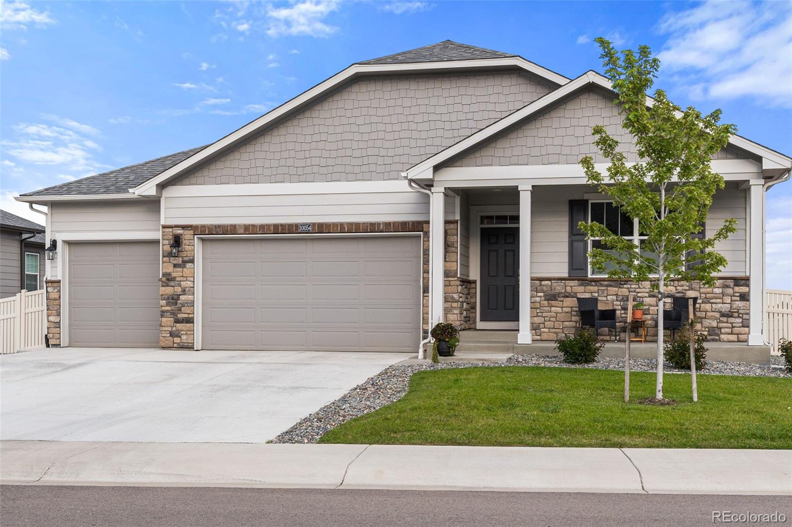 10054 Carefree Street Firestone, CO 80504 - Photo 4 of 50 a front view of a house with a yard and garage