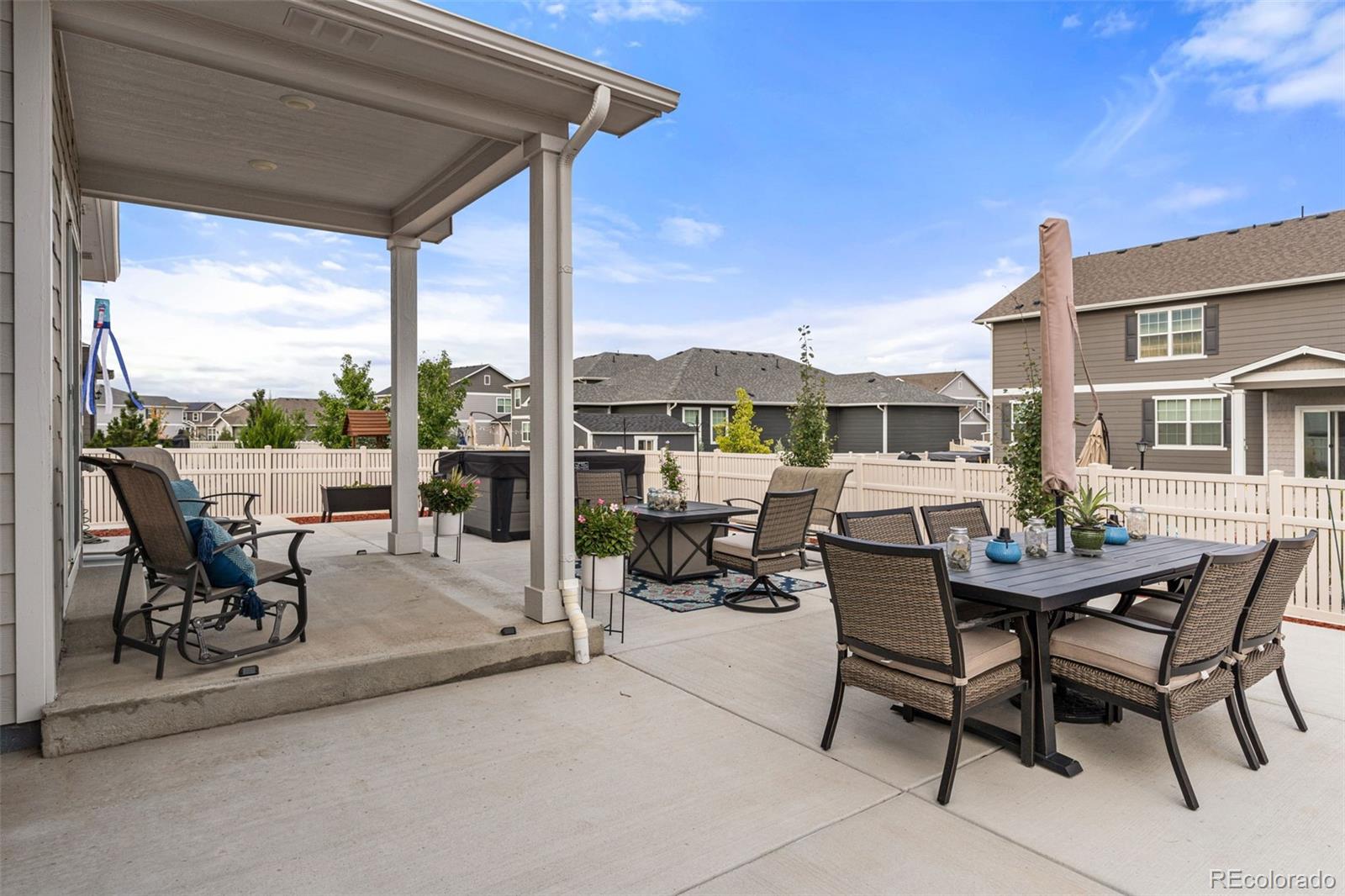 10054 Carefree Street Firestone, CO 80504 - Photo 47 of 50 a view of a patio with a dining table and chairs