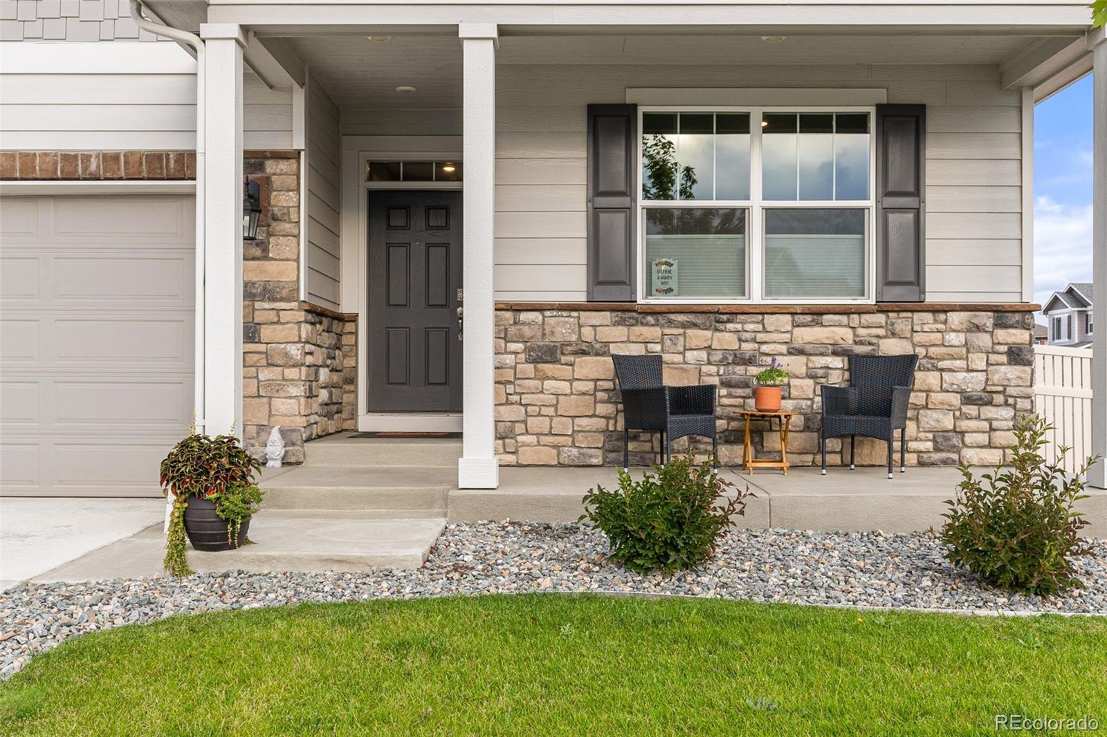 10054 Carefree Street Firestone, CO 80504 - Photo 5 of 50 a front view of a house with garden