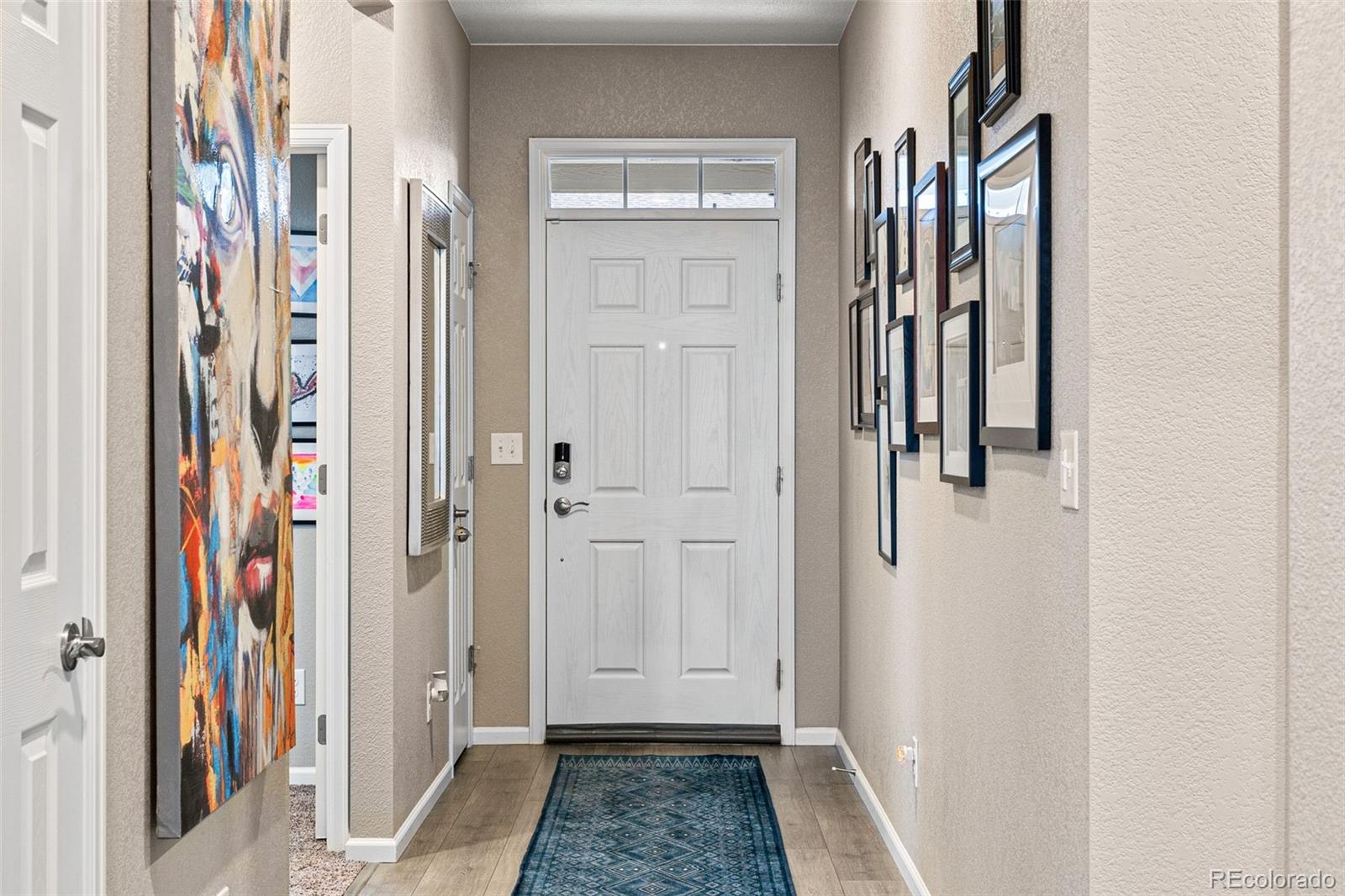 10054 Carefree Street Firestone, CO 80504 - Photo 6 of 50 a view of a hallway with a wooden door