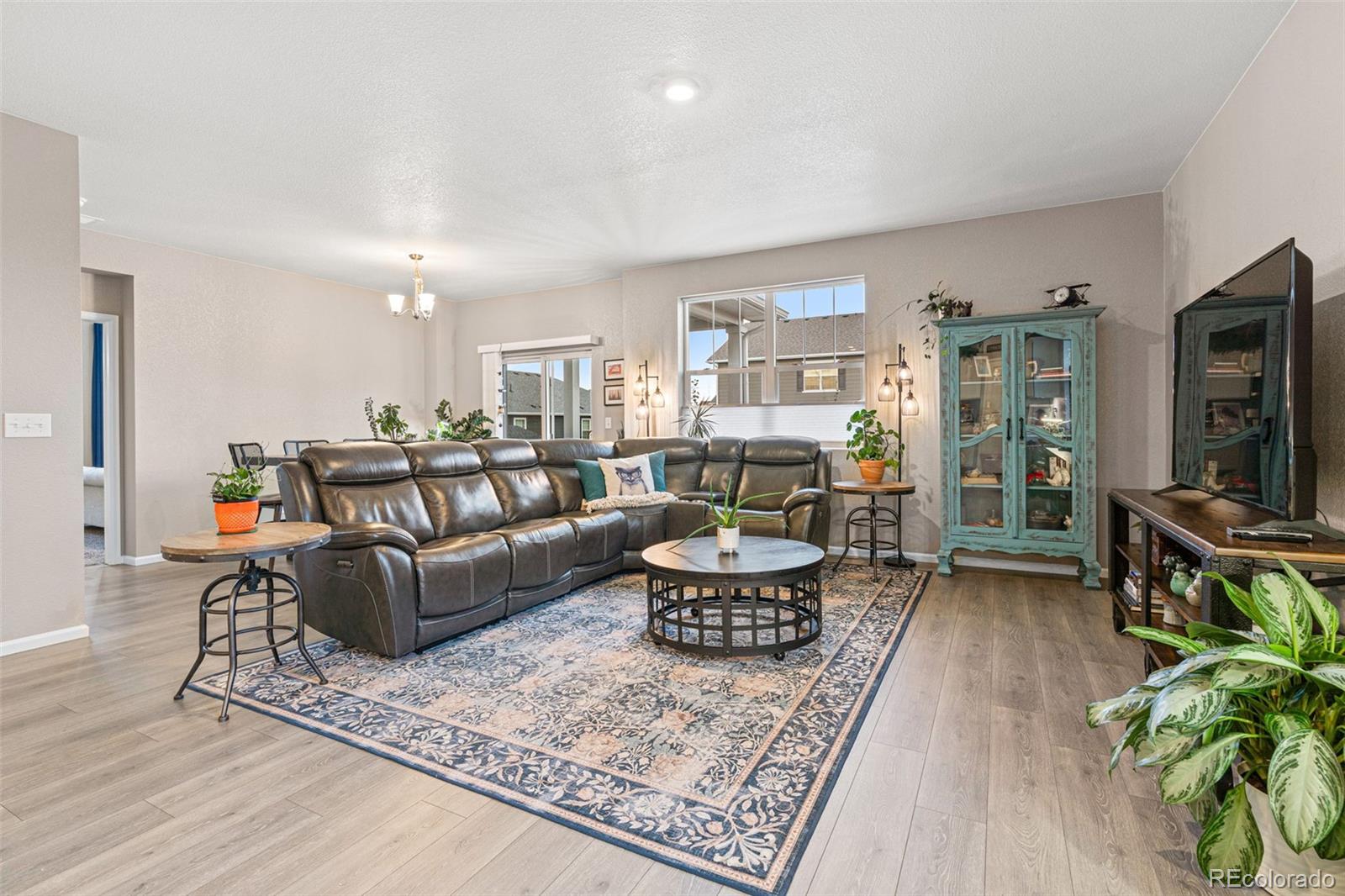 10054 Carefree Street Firestone, CO 80504 - Photo 10 of 50 a living room with furniture a flat screen tv and a table