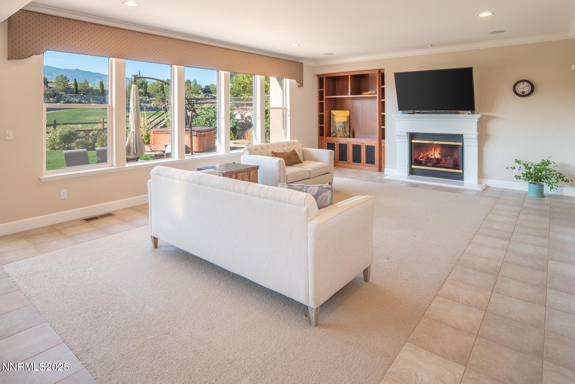 8310 Cinnamon Ridge Lane Reno, NV 89523 - Photo 7 of 34 a living room with furniture and a flat screen tv