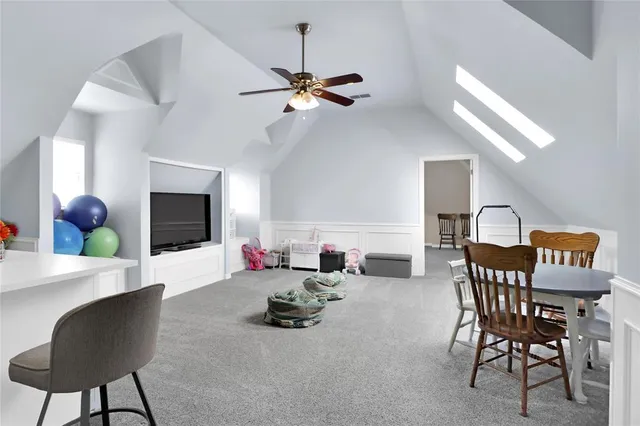 a white kitchen with cabinets and chairs