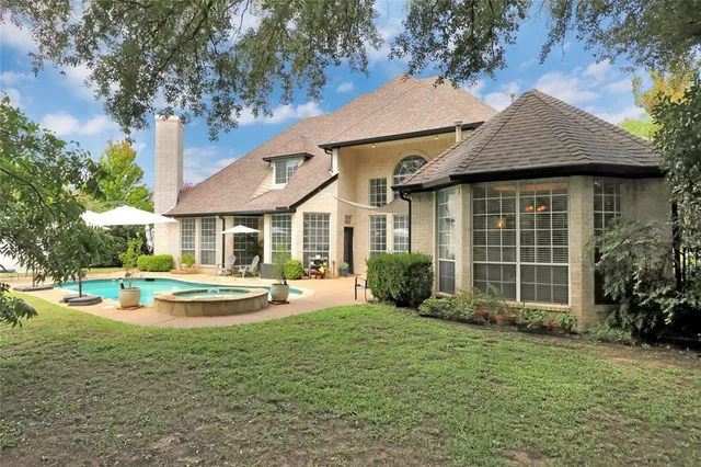 a house view with swimming pool and outdoor seating