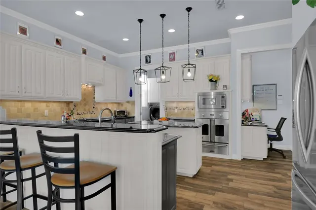 a kitchen with refrigerator and cabinets