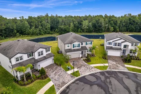 an aerial view of a house with garden space and a swimming pool