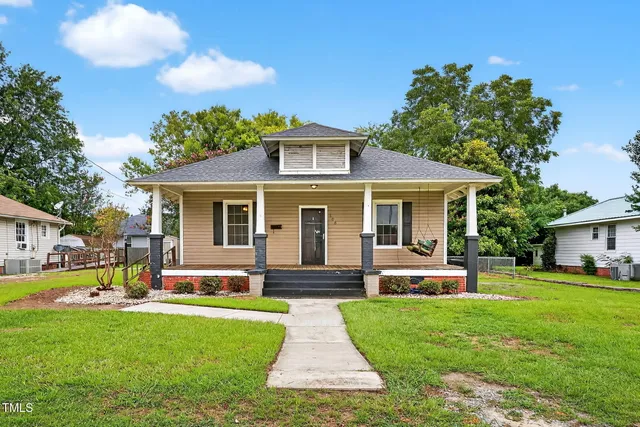 a front view of house with yard and green space