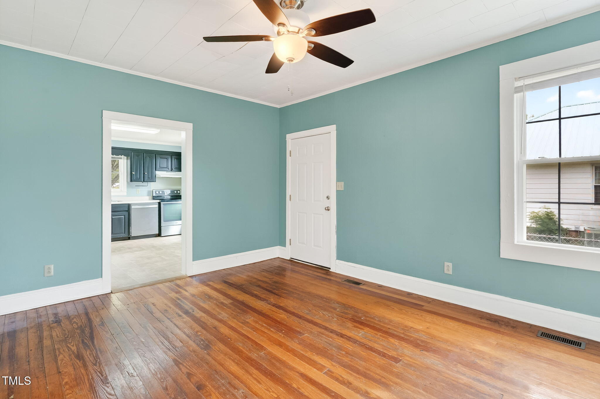 108 West C Street Erwin, NC 28339 - Photo 13 of 37 a view of empty room with wooden floor and fan
