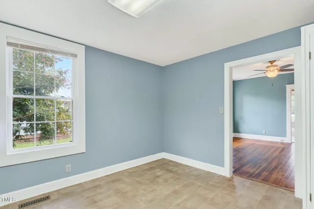 an empty room with windows and closet