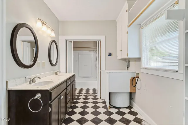 a bathroom with a sink toilet and a mirror