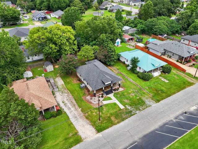 an aerial view of a house with a garden and swimming pool