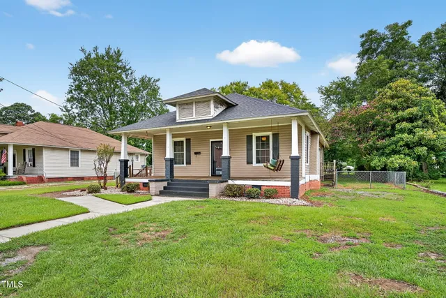 a view of a house with a yard porch and sitting area