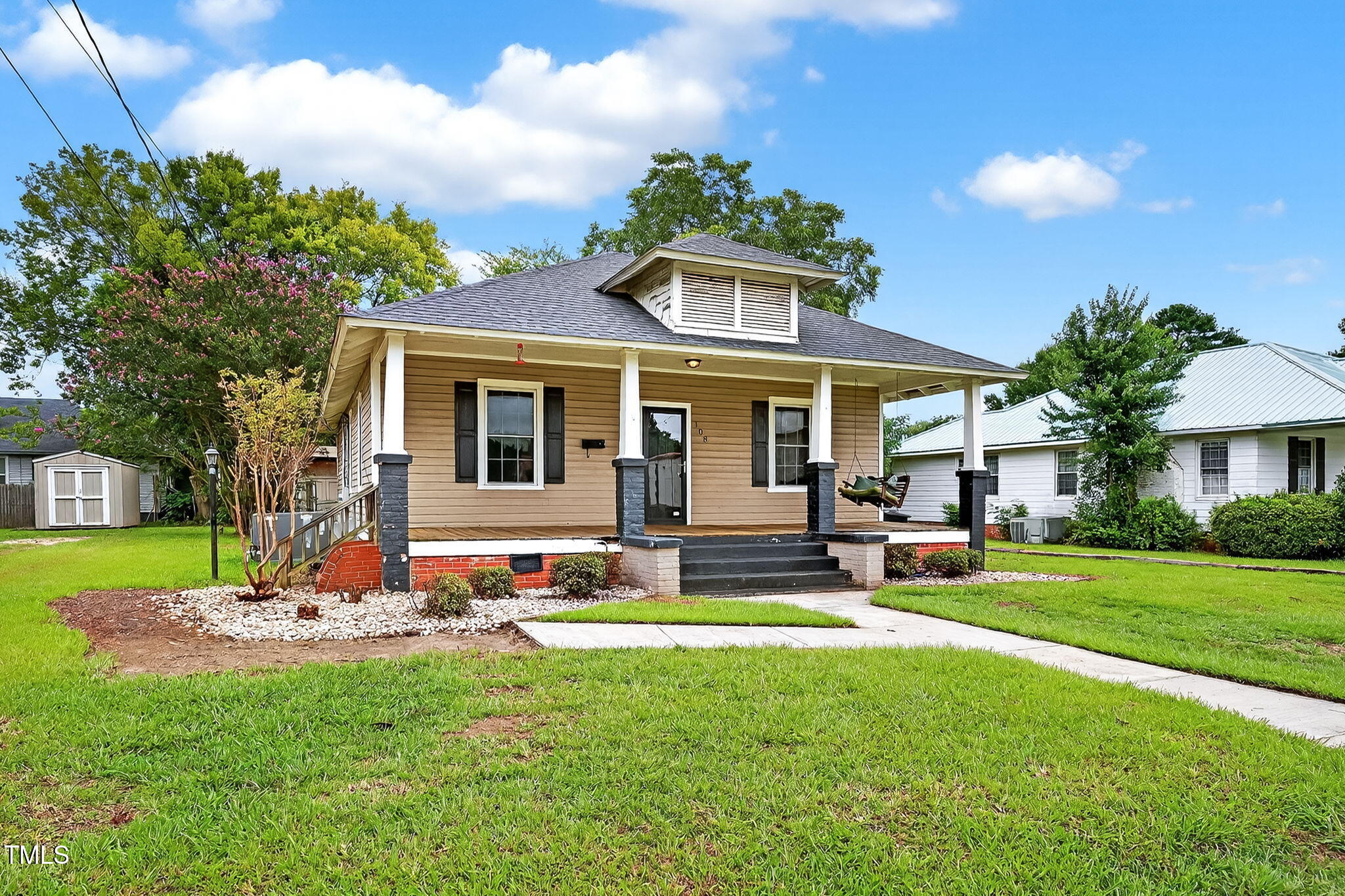 108 West C Street Erwin, NC 28339 - Photo 4 of 37 a front view of a house with garden and trees