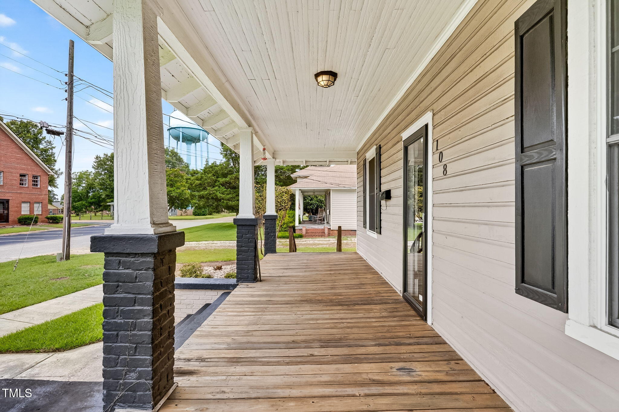 108 West C Street Erwin, NC 28339 - Photo 6 of 37 a view of a porch with wooden floor and floor to ceiling window