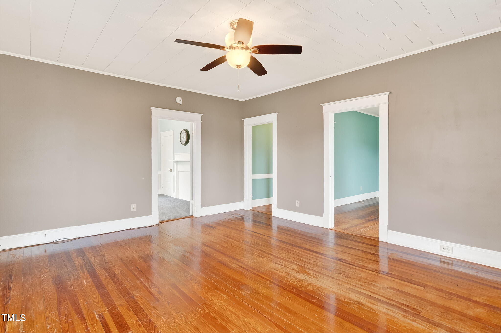 108 West C Street Erwin, NC 28339 - Photo 8 of 37 an empty room with wooden floor and ceiling fan