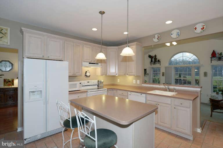 1408 Clearview Road Edgewood, MD 21040 - Photo 5 of 26 a kitchen with kitchen island cabinets and refrigerator