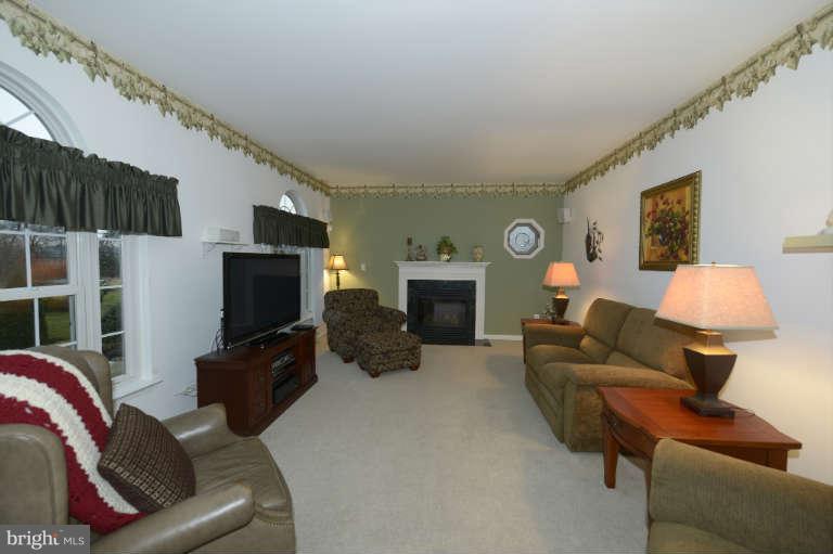 1408 Clearview Road Edgewood, MD 21040 - Photo 8 of 26 a living room with furniture a flat screen tv and a fireplace