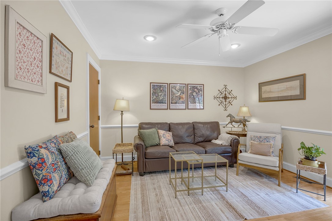218 Northridge Drive Anderson, SC 29621 - Photo 27 of 50 Recessed lighting and a classic ceiling fan illuminate this inviting living area, featuring rich hardwood floors and elegant crown molding.