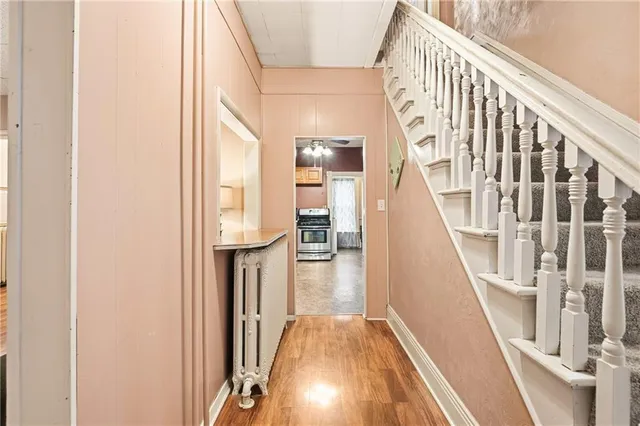 a view of entryway and hall with wooden floor
