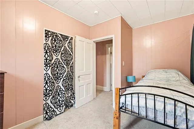 a bedroom with a bed and a shower